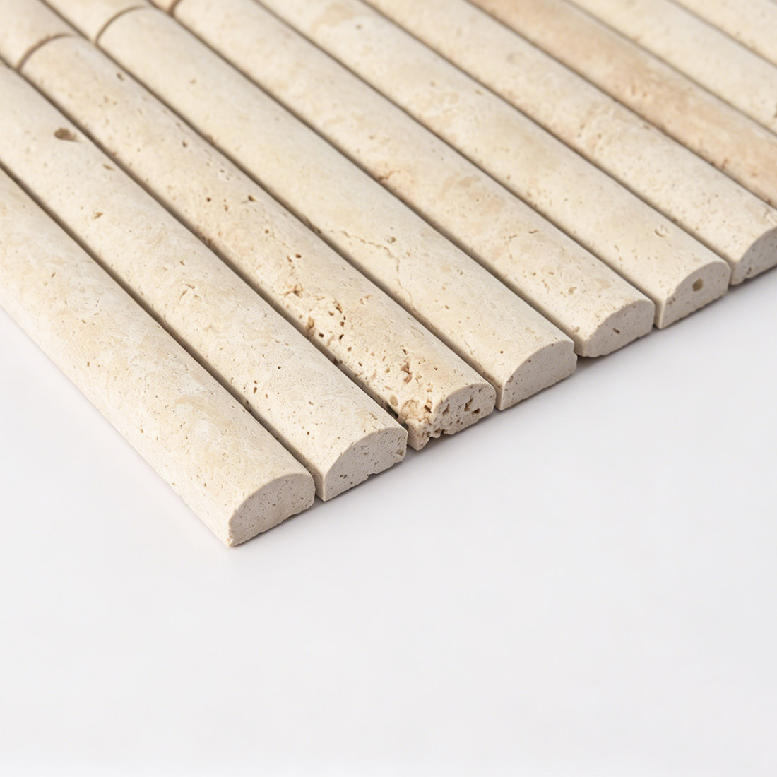 Side profile view highlighting the curved tubular shape of beige travertine.