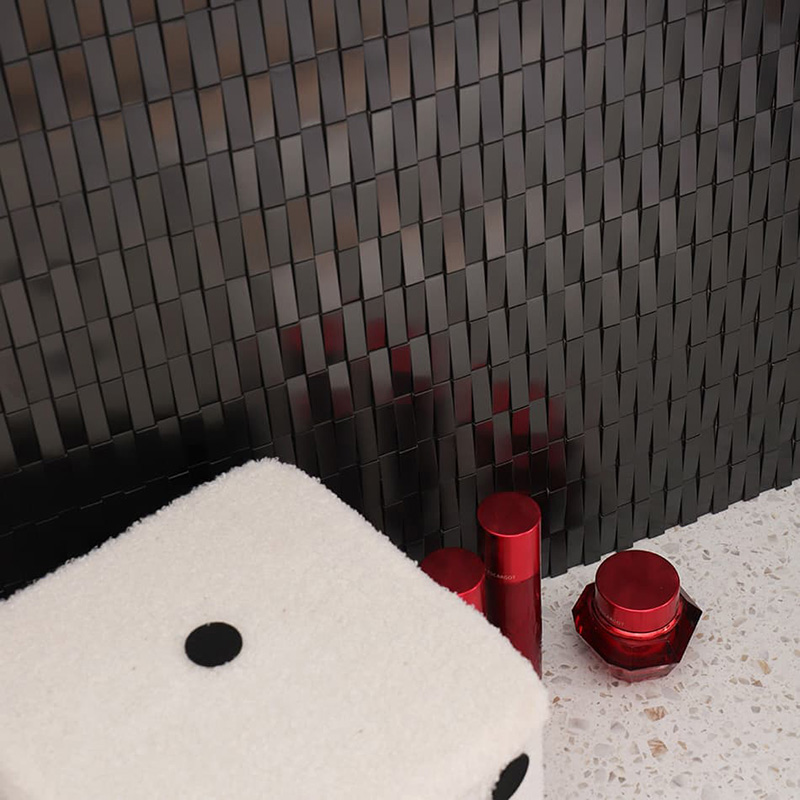 Angled view of 3D black metal wall tiles with a premium brushed finish.