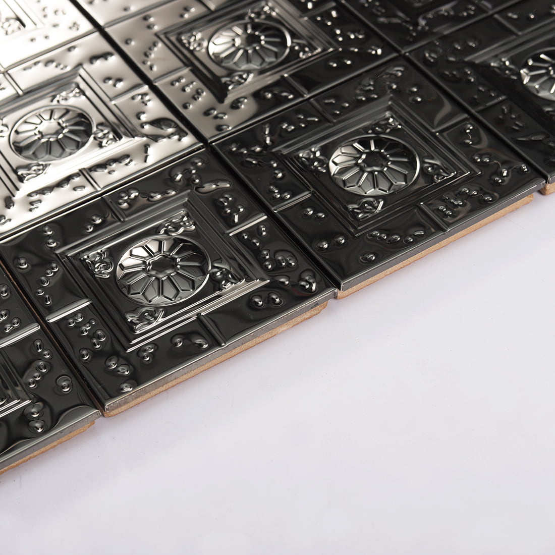 Edge detail of black embossed square metal mosaic tile sheet