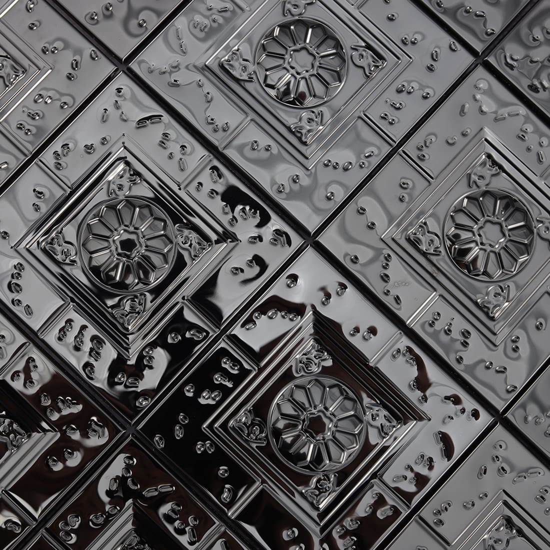 Close-up of black embossed square metal mosaic tile surface