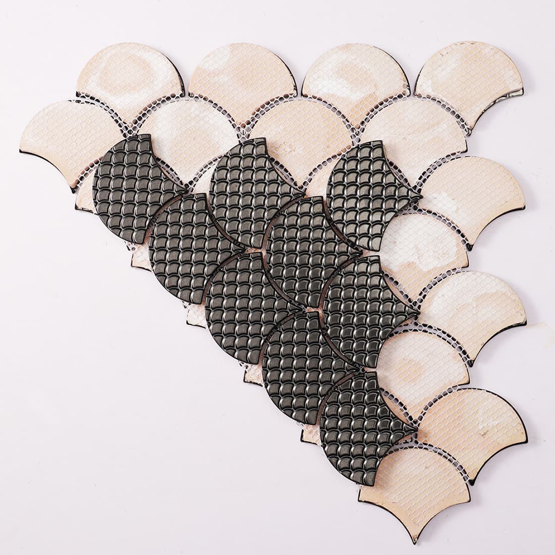 Back view of black fish scale metal mosaic tile with mesh backing