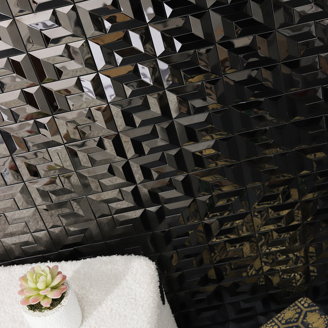 Black geometric 3D metal mosaic tile wall behind sofa