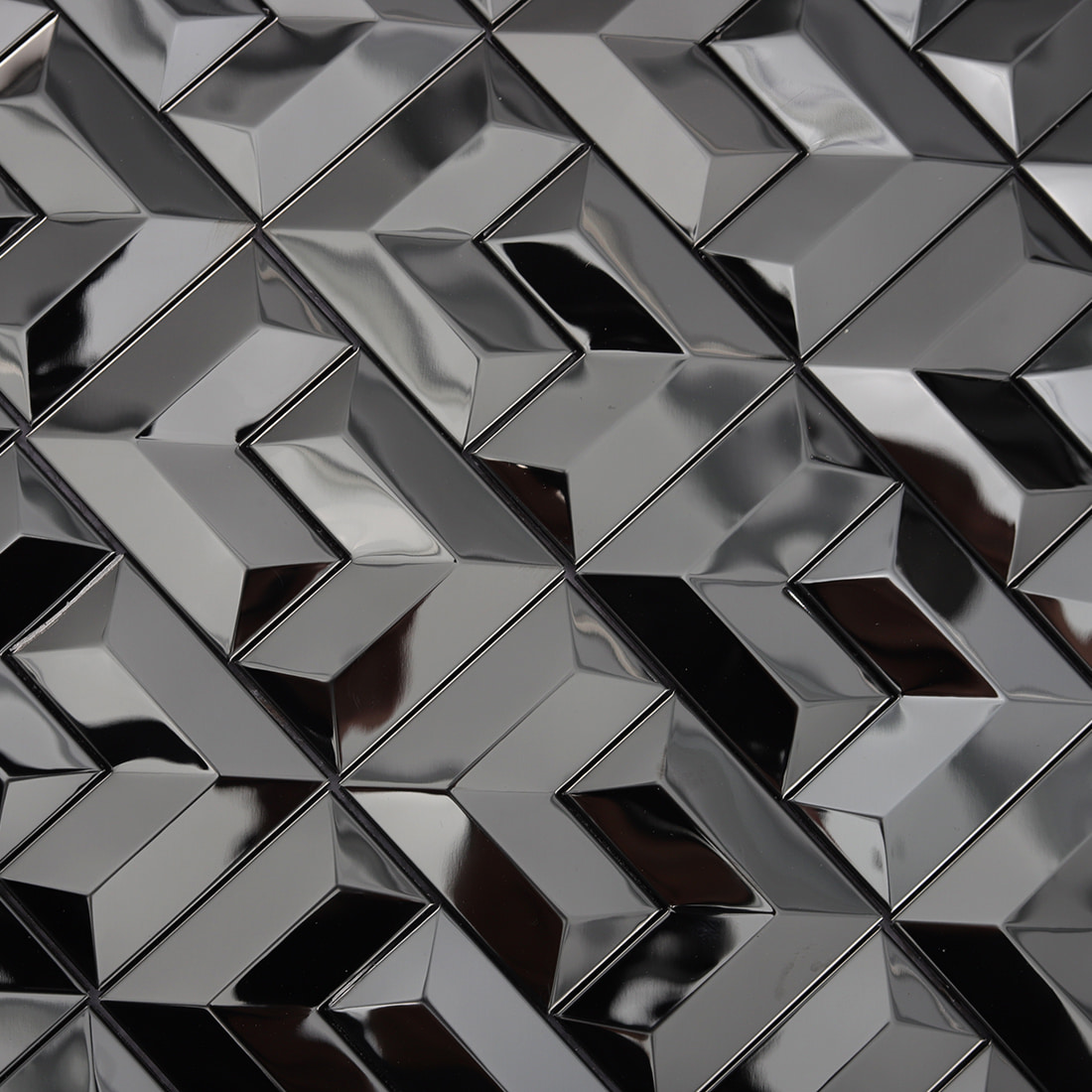 Close-up of black geometric 3D metal mosaic tile surface