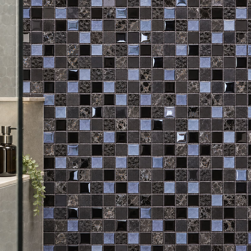 Close-up of black glass shower tiles with blue accents and mixed textures
