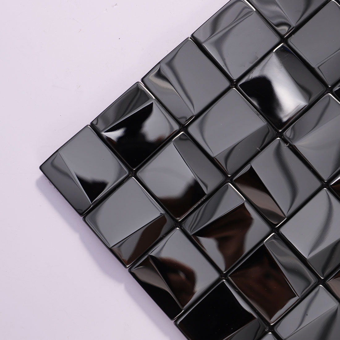 Close-up of black glossy square stainless steel mosaic tiles