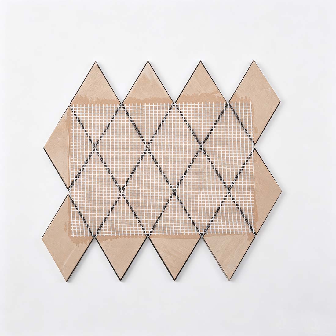 Mesh mounted backing of black and gold rhombus metal mosaic for easy installation