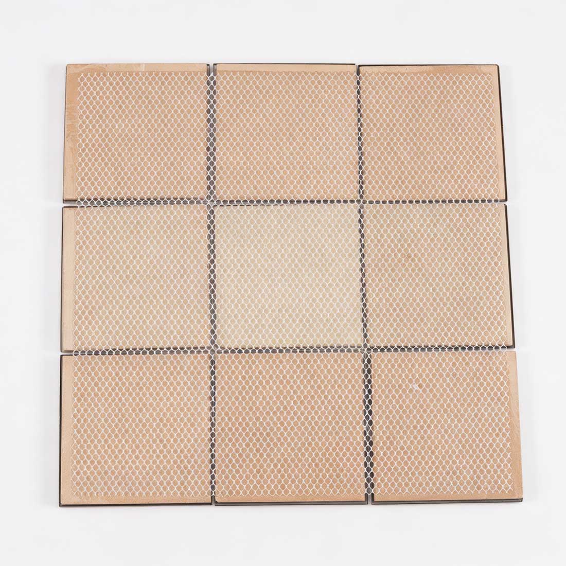 Back view of mesh mounted black and gold square metal mosaic sheet