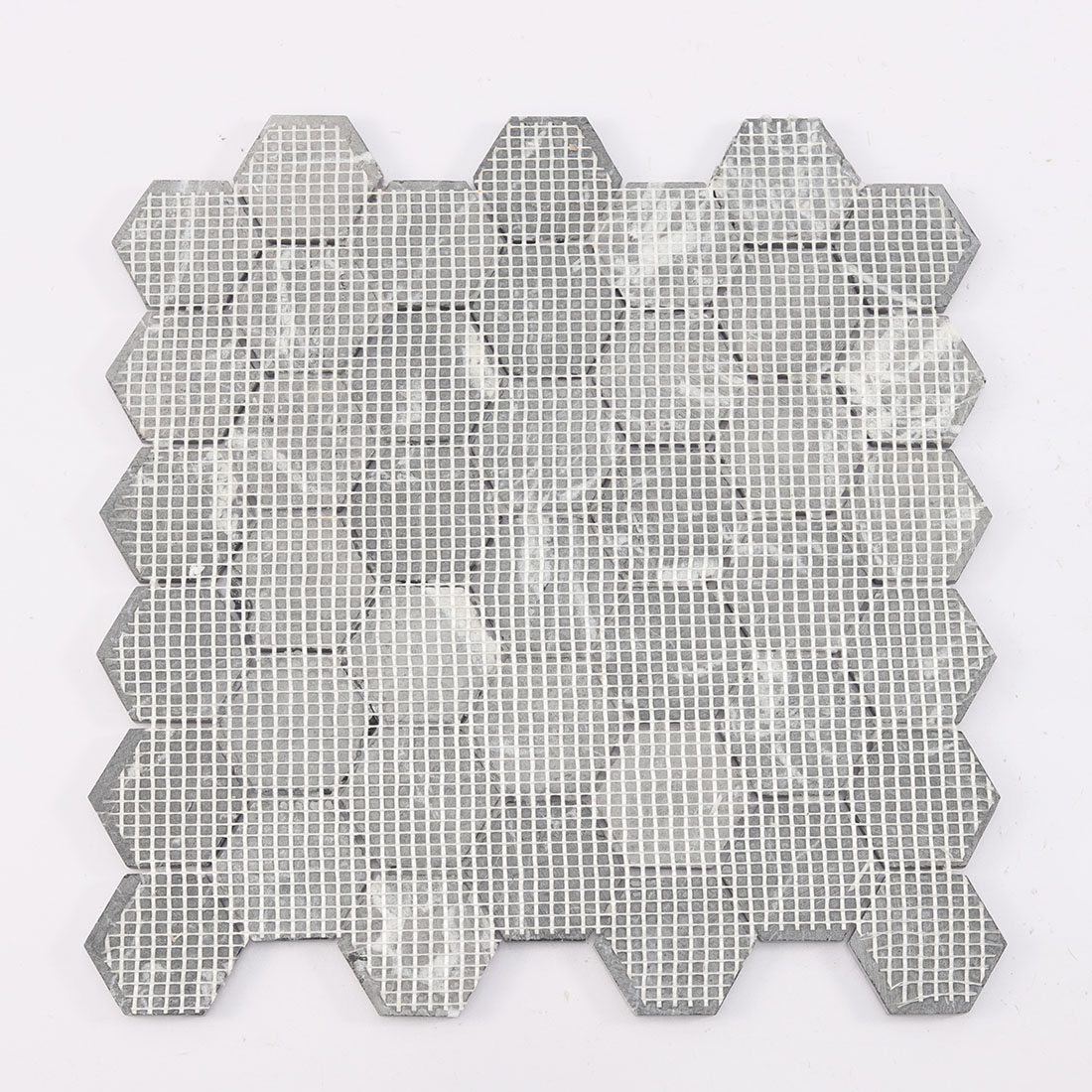 Back view of black hexagon marble mosaic tile on white mesh backing