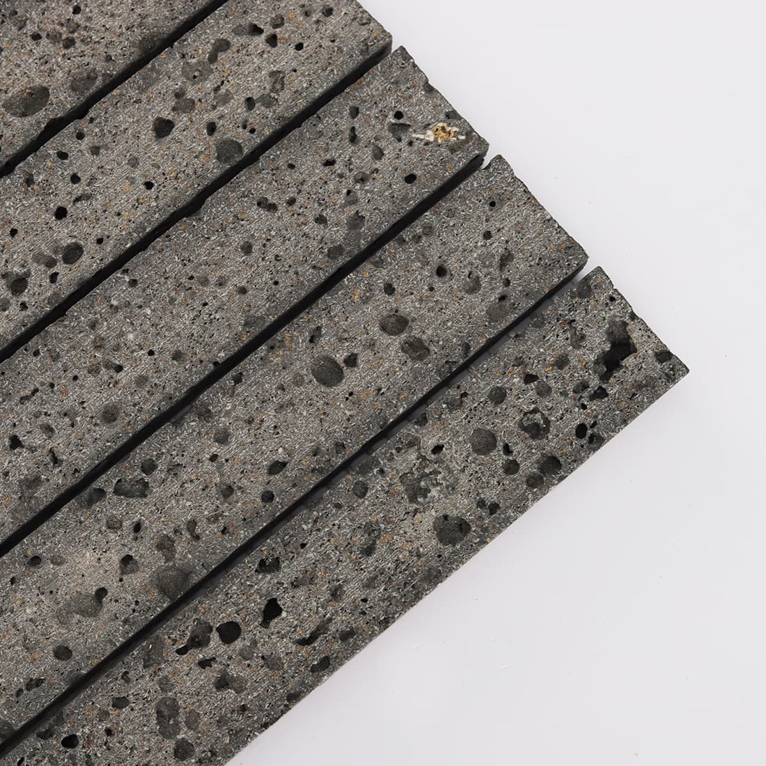 Corner detail of black lava stone fluted mosaic tile