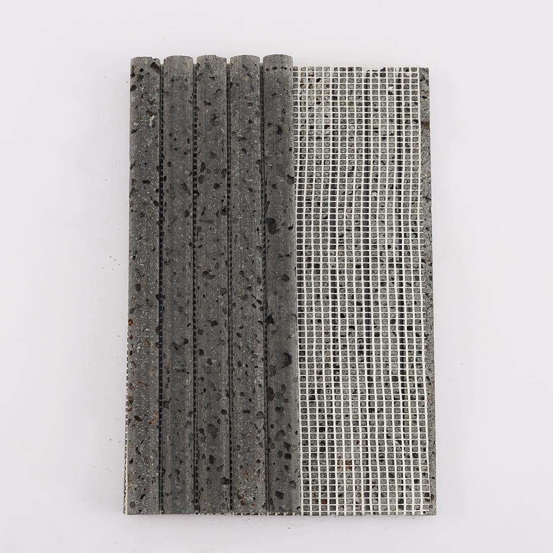 Back view of black 3D raised lava stone strip mosaic tile with mesh backing