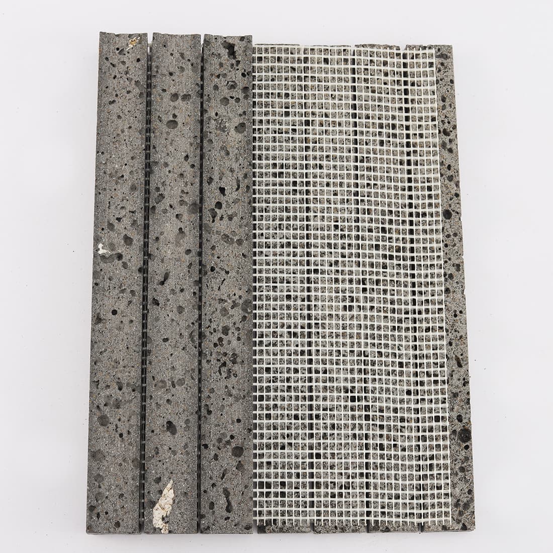 Back view of black lava stone fluted mosaic tile with mesh backing