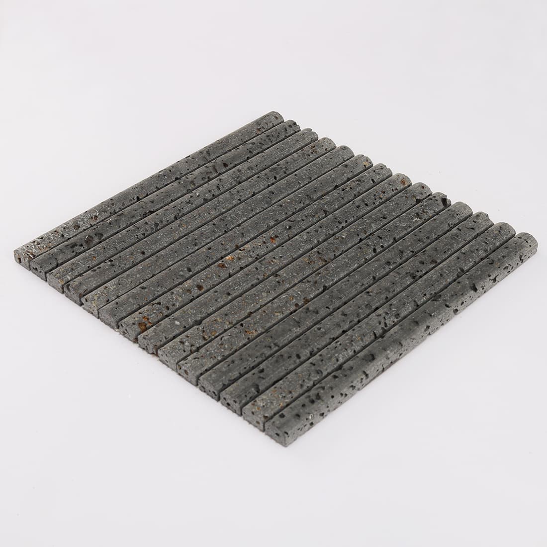 Perspective view of black 3D raised lava stone strip mosaic tile sheet