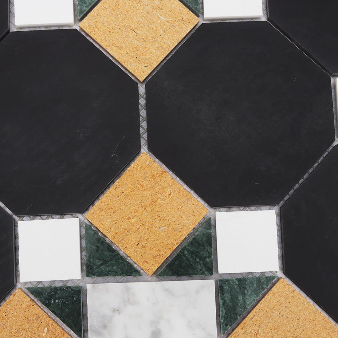 Pattern detail of black octagon mosaic with gold white and green stone inserts