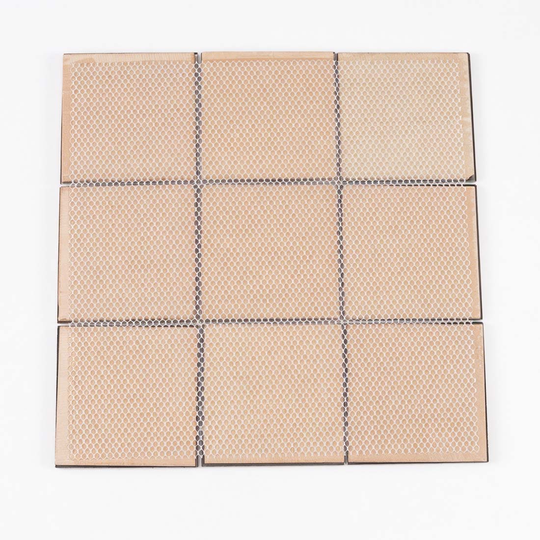 Back view of mesh mounted black and rose gold square metal mosaic sheet