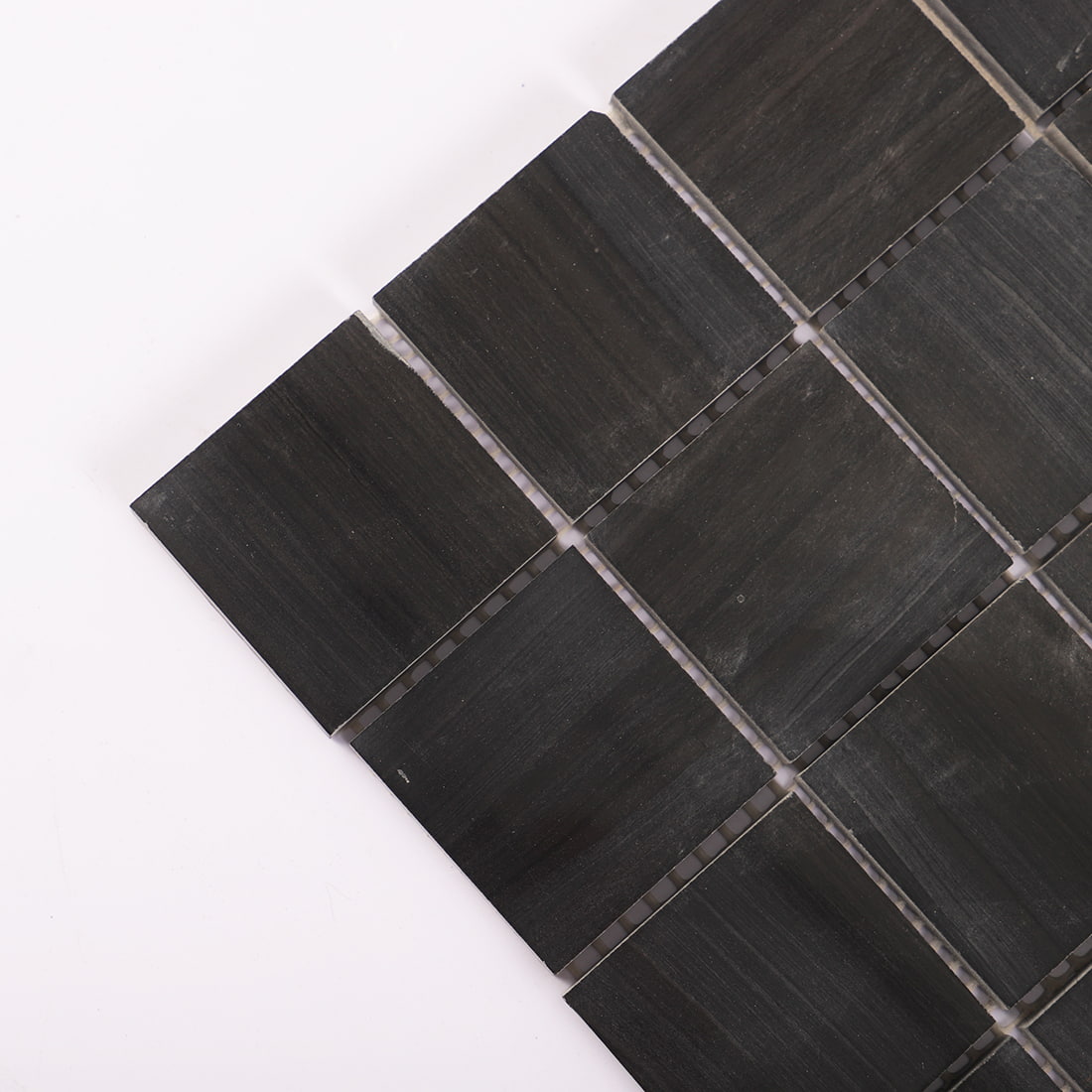 Corner detail of black square marble mosaic tile sheet