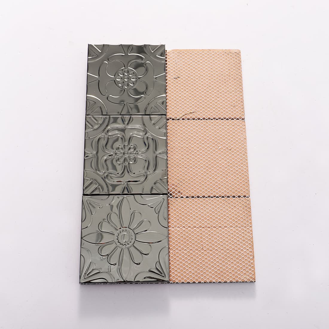 Front and mesh back view of black stainless steel embossed mosaic tiles