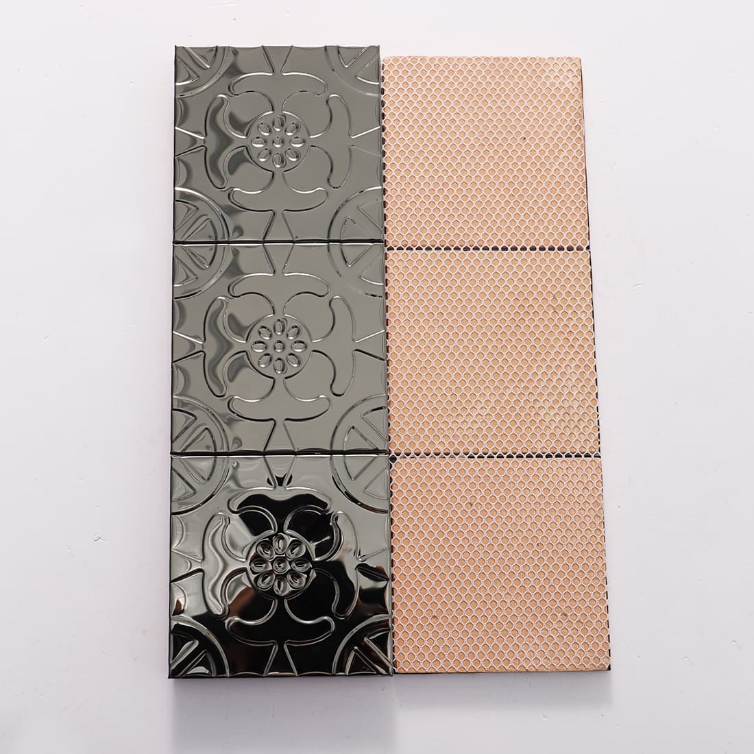 Front and mesh back view of black stainless steel floral embossed tiles