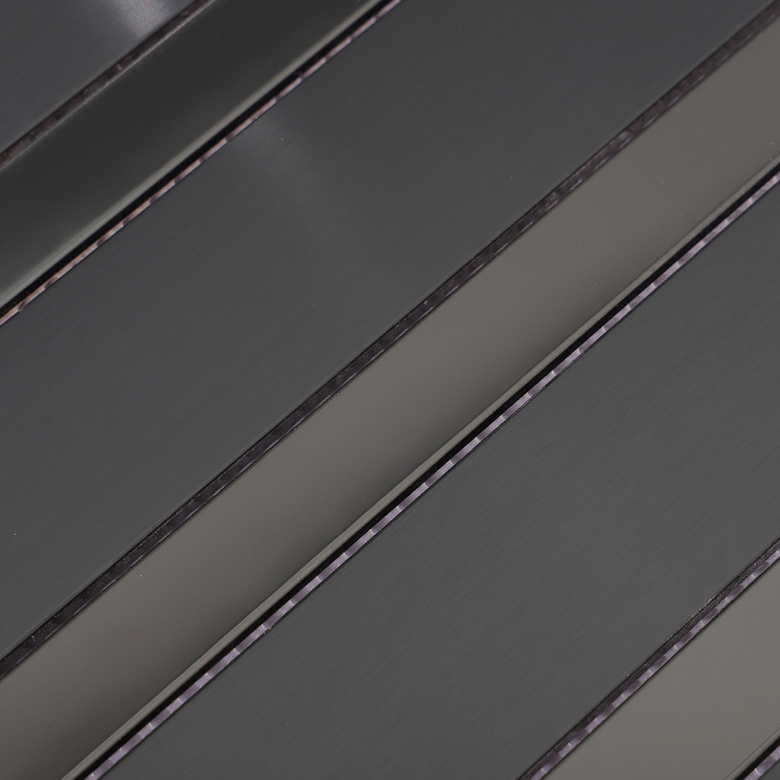 Close-up of black strip metal mosaic tile surface