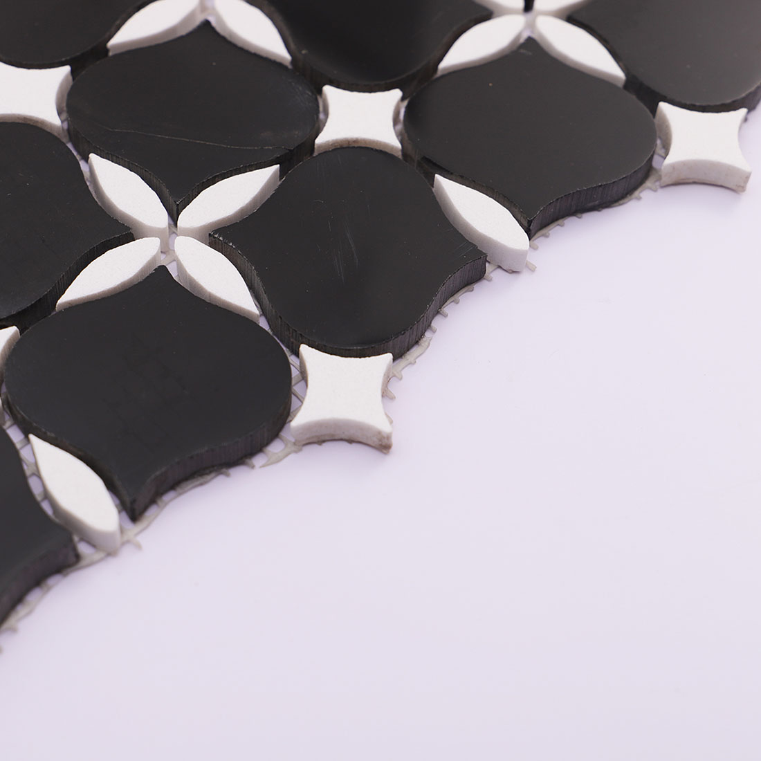 Black and white arabesque marble mosaic tile side view showing thickness detail.