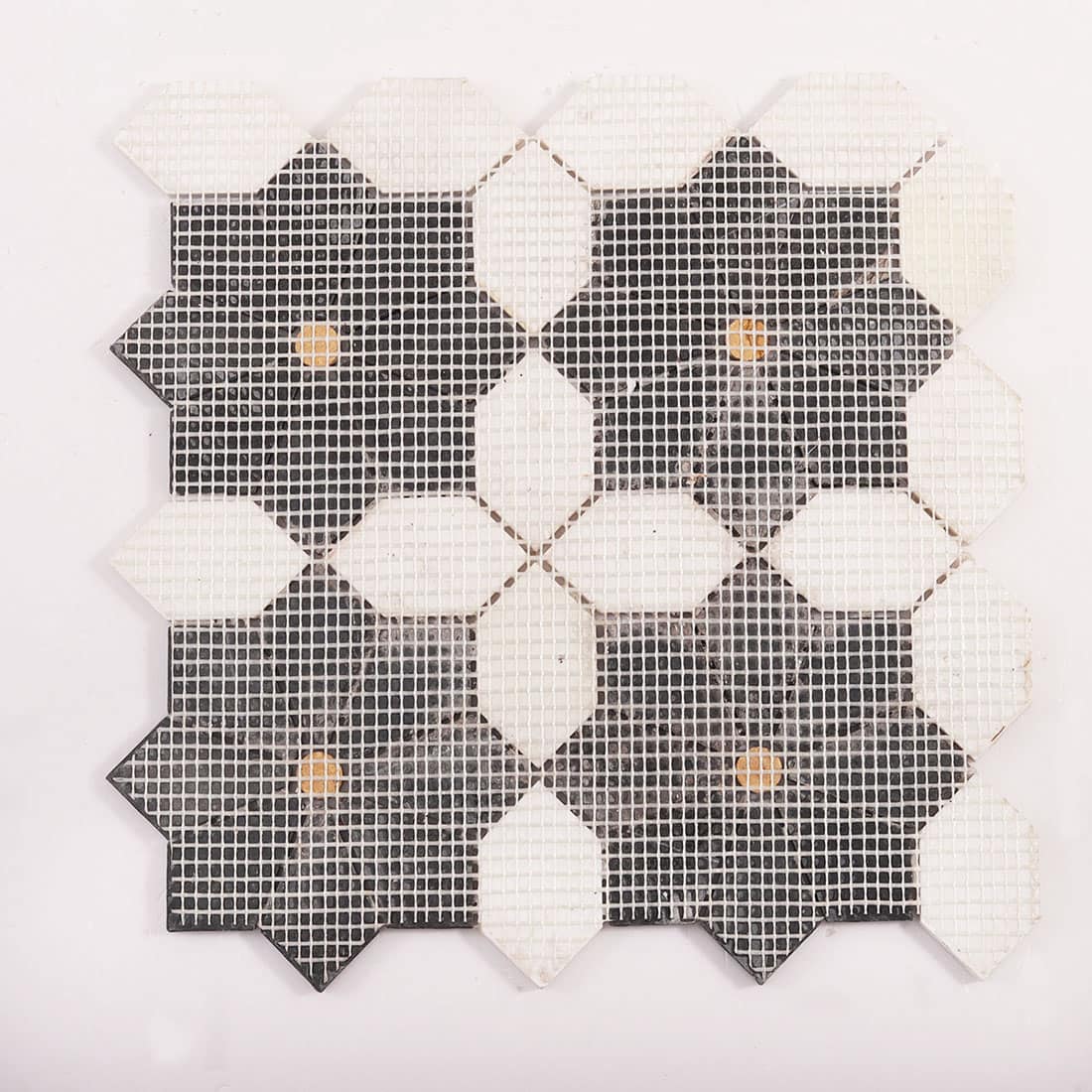 Back view of the mosaic sheet showing mesh backing and tile placement