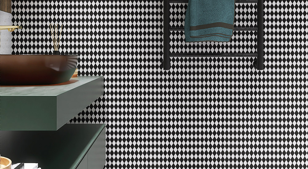 {"default":"Bathroom scene with black and white diamond checkerboard wall, modern vanity, and blue towel."}
