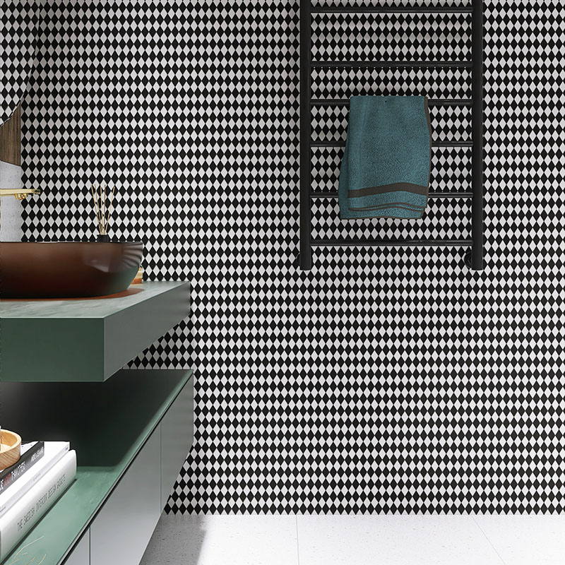 Black and white diamond tiled wall and green vanity in a full bathroom view with white floors.