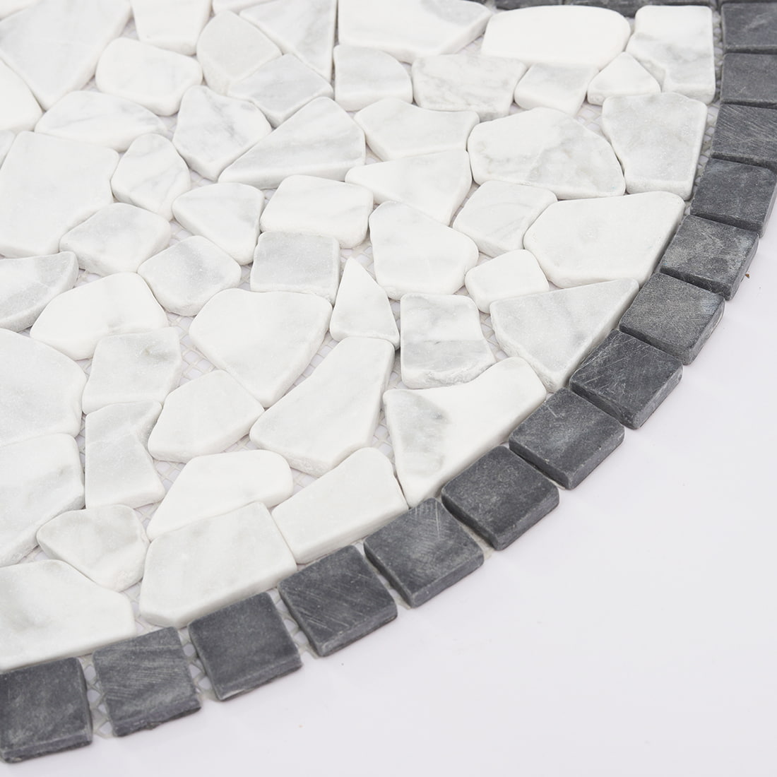 Detail of black and white pebble marble mosaic with curved border