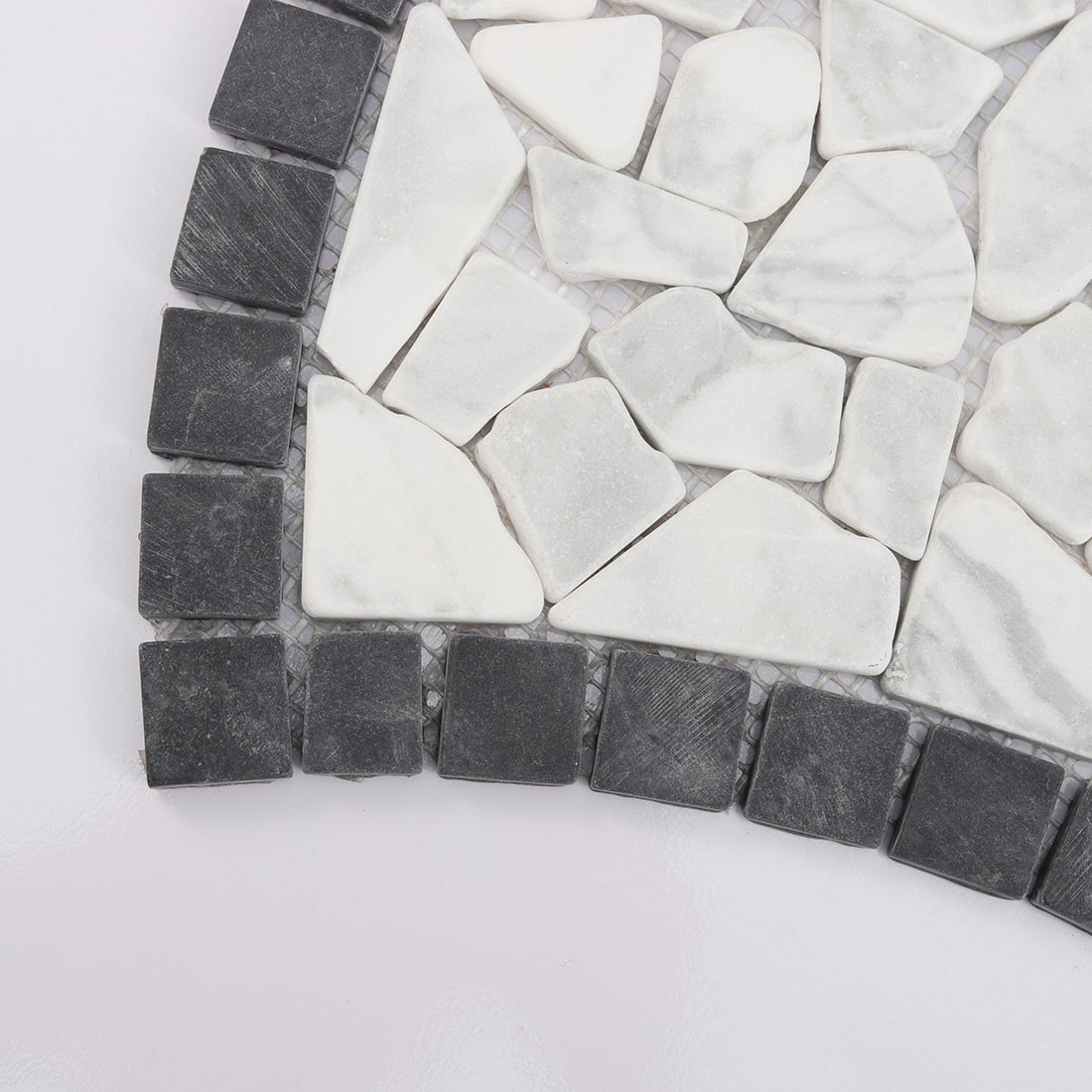 Corner detail of black and white pebble marble mosaic tile