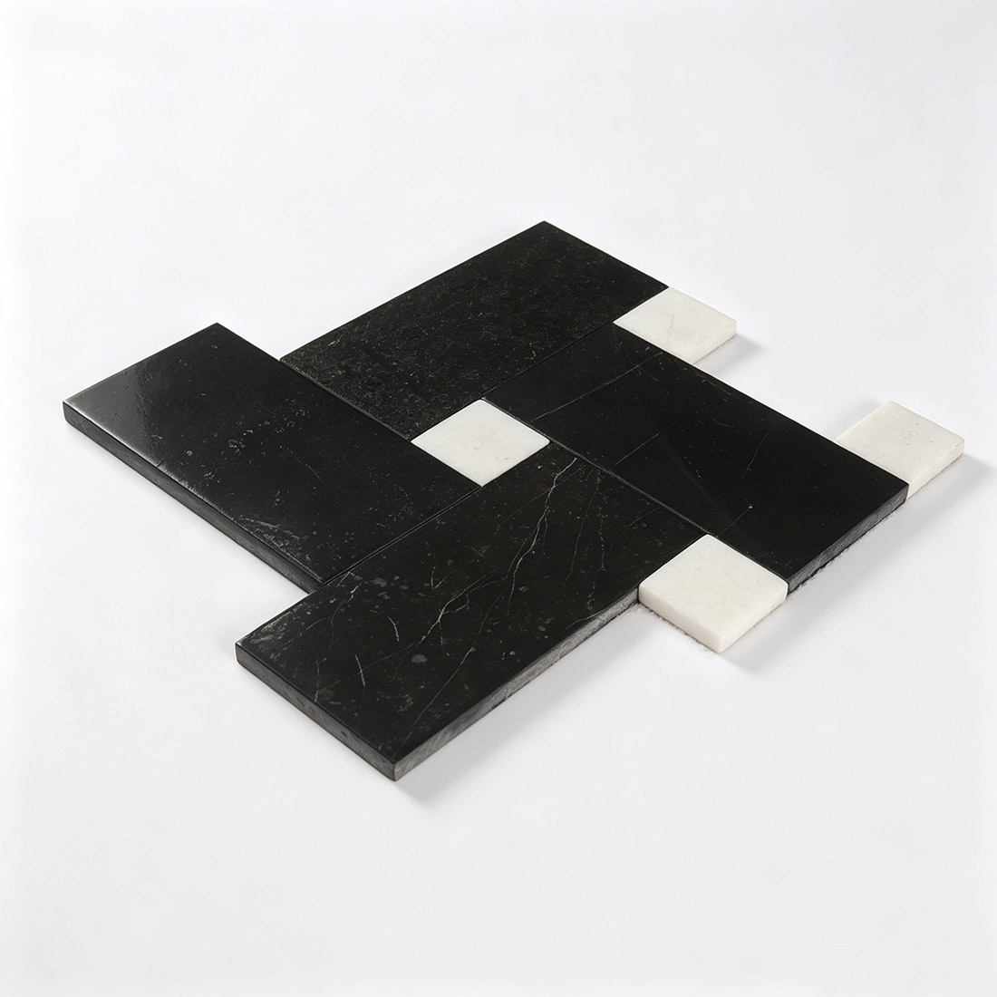 Perspective view of laid black and white pinwheel marble mosaic sheet