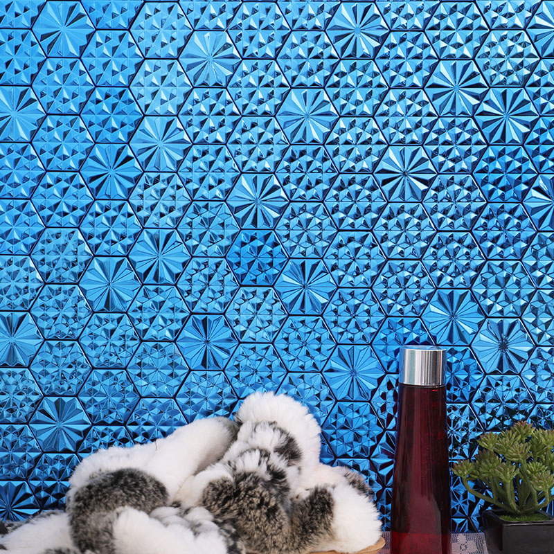 Blue 3D metal hexagon tiles with faceted geometric patterns on a decorative wall