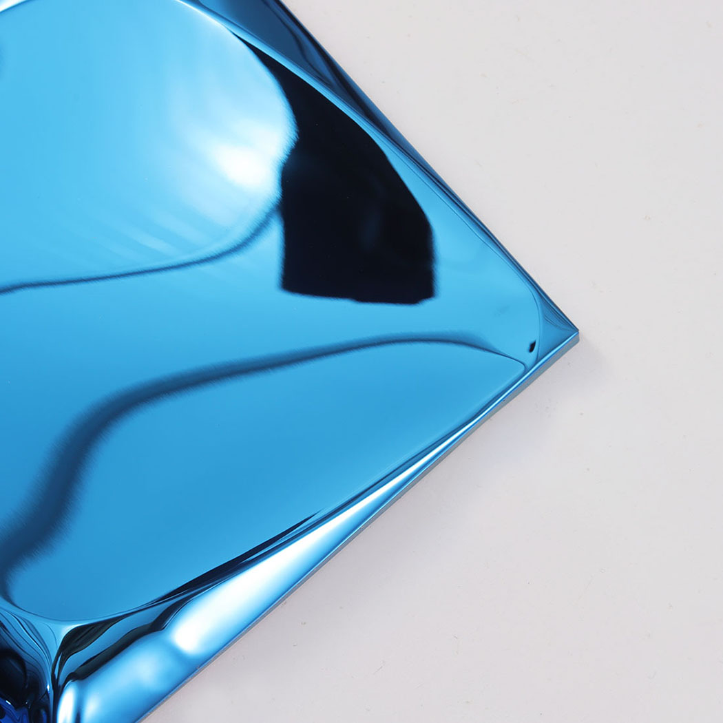 Closeup of blue 3D metal tile corner with glossy curved reflections
