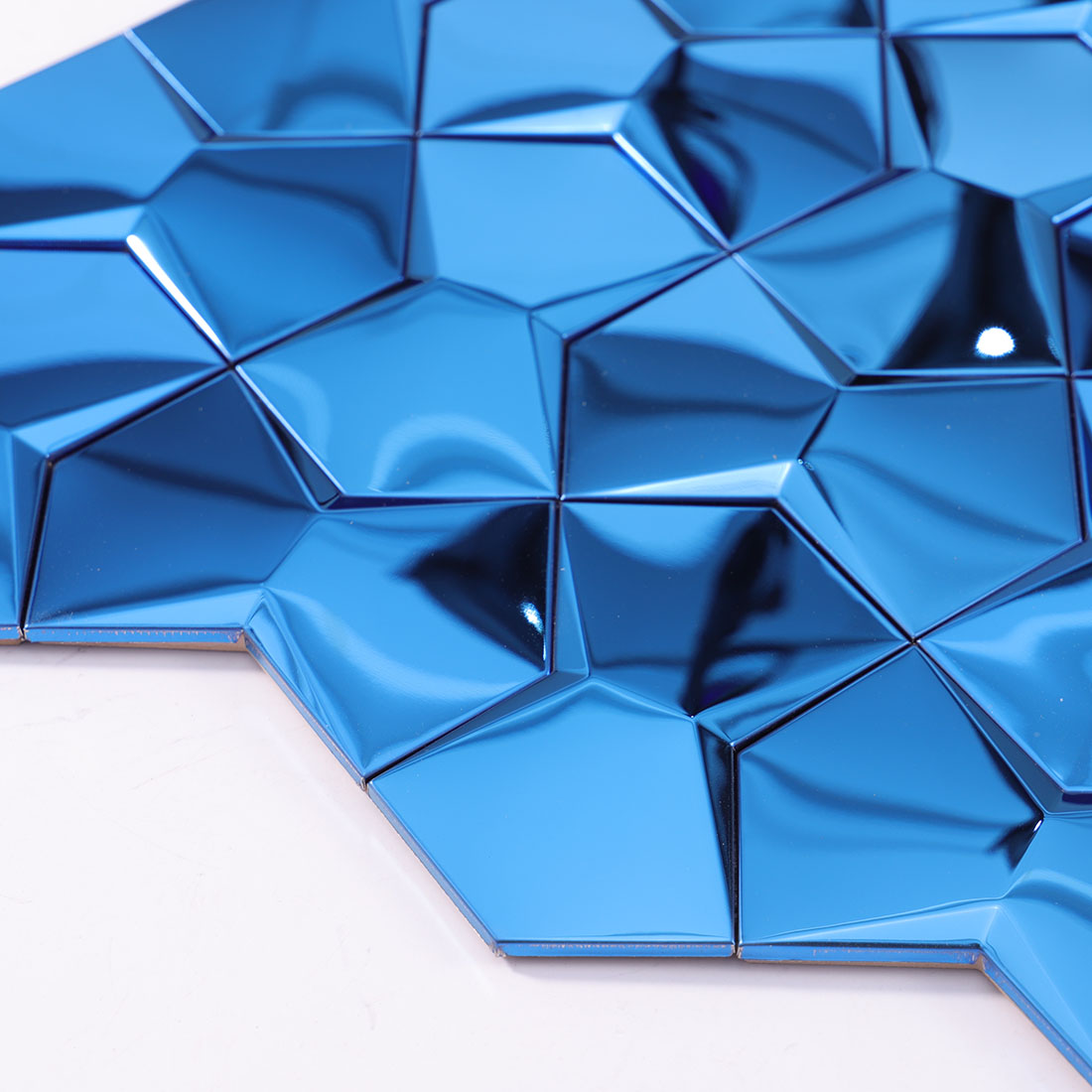 Close up corner detail of 3D mirror blue geometric metallic mosaic tile