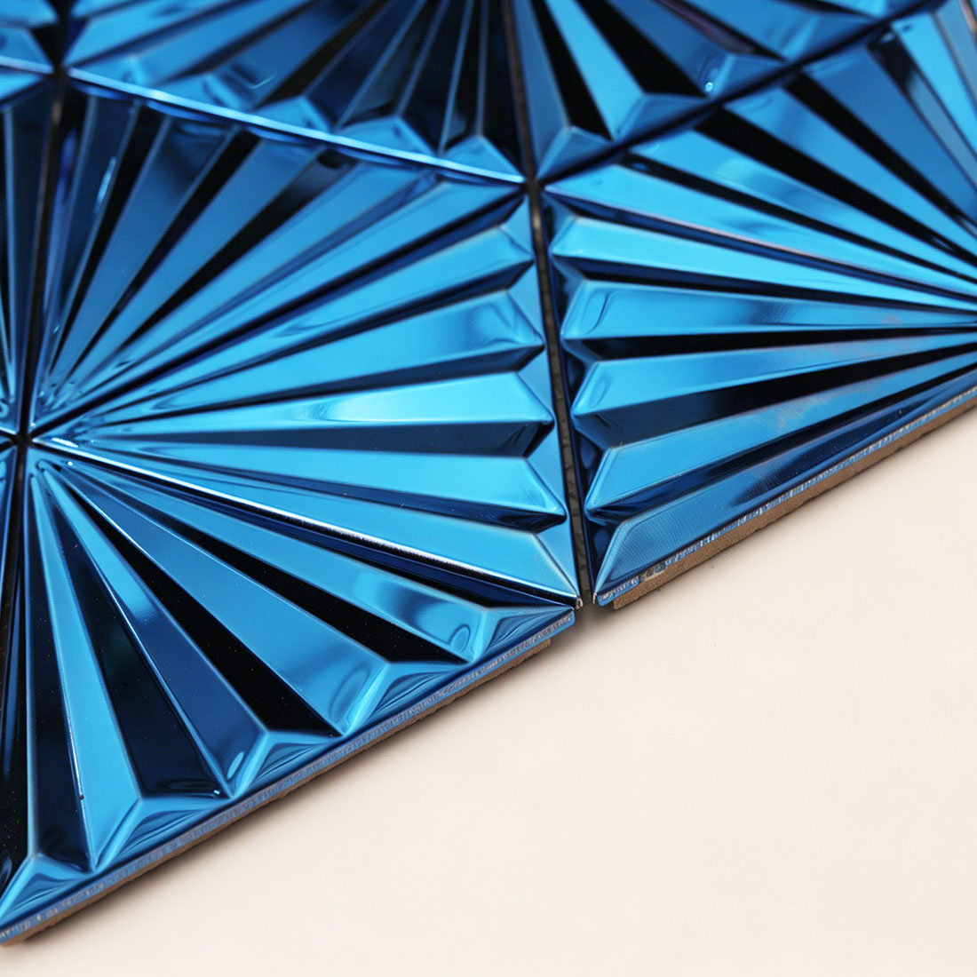 Low angle view of blue fan triangle metal mosaic showing beveled edge