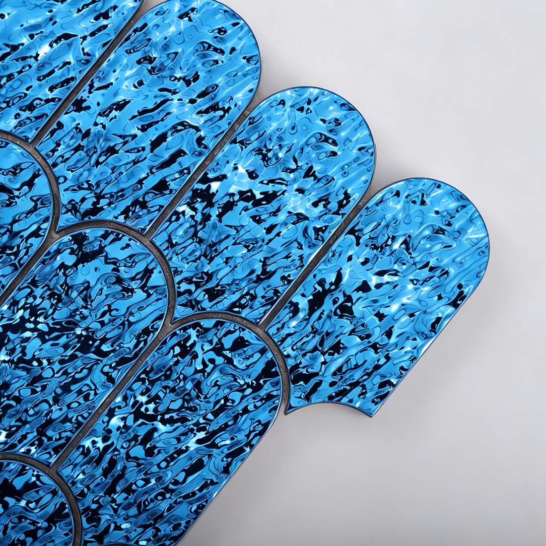 Close up of blue fish scale metal mosaic tile individual chips