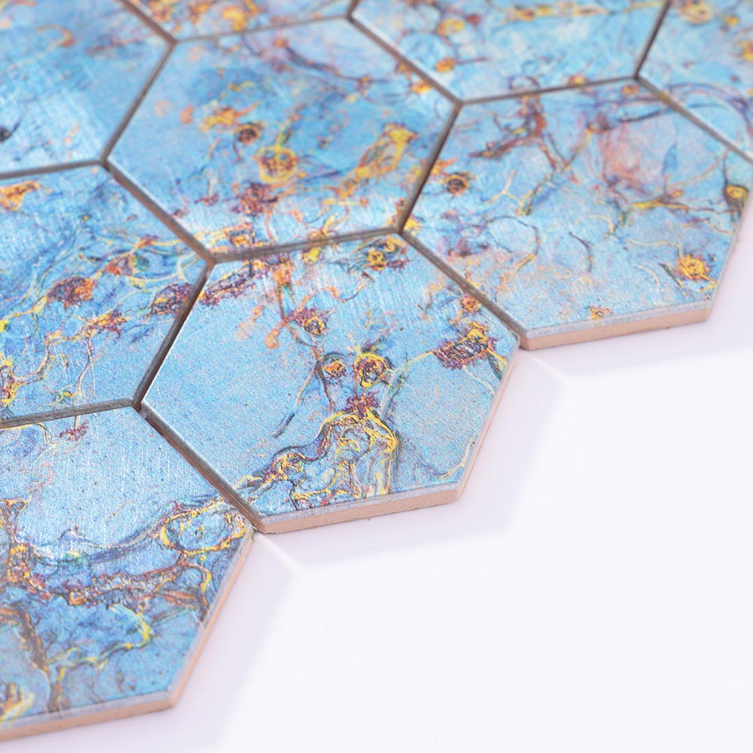 Angle shot of blue gold marbled hexagon aluminum mosaic tile showing edge
