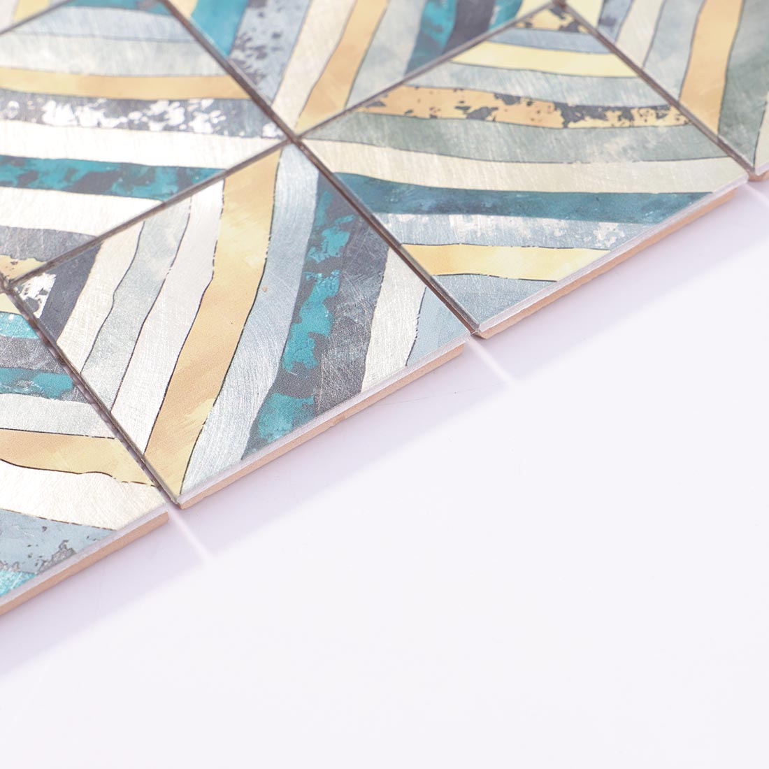 Angle shot of blue gold striped square aluminum mosaic tile showing edge