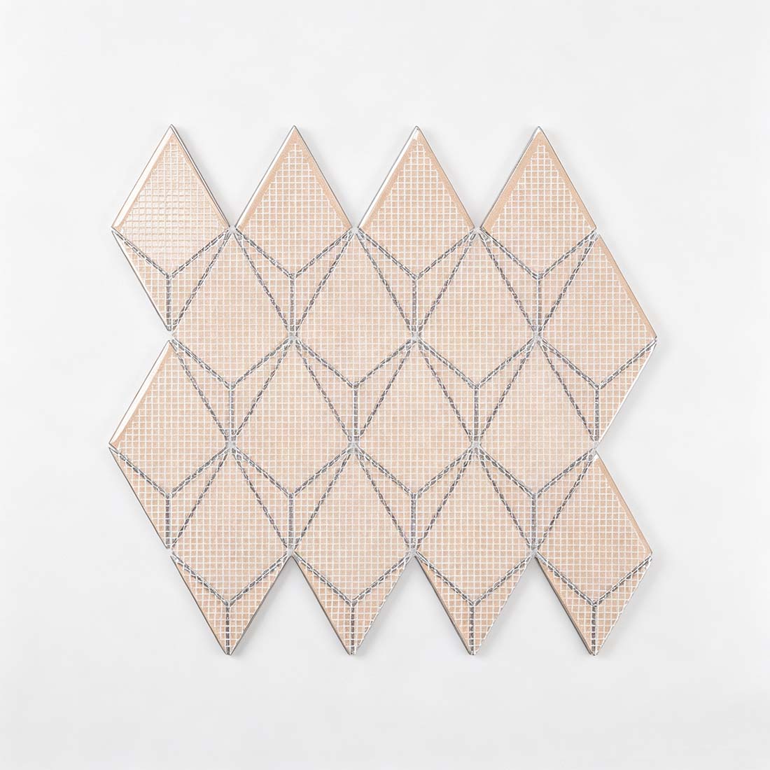 Mesh mounted backing of blue kite-shaped metal mosaic tile for easy installation