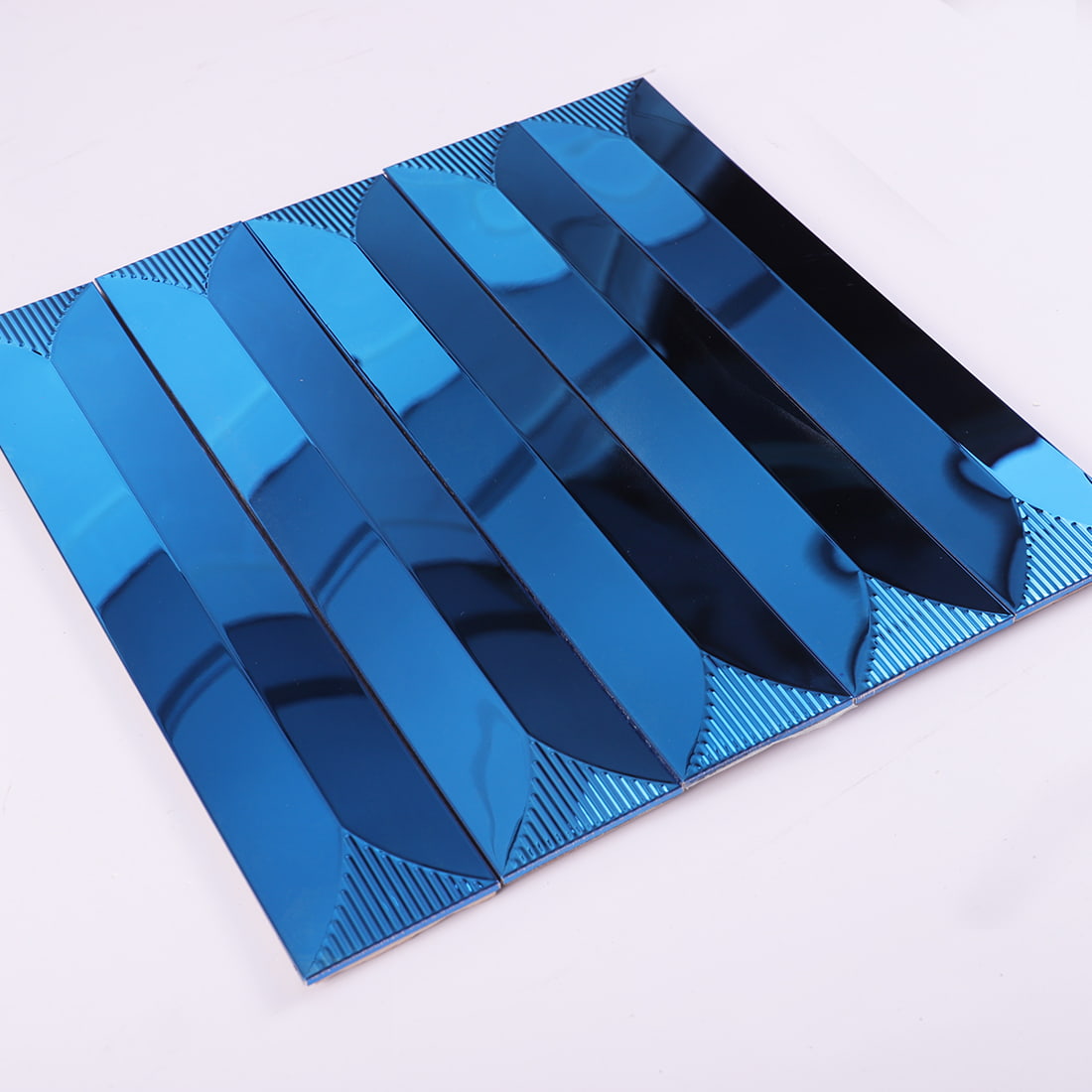 Angled view of blue long strip bevel metal mosaic sheet