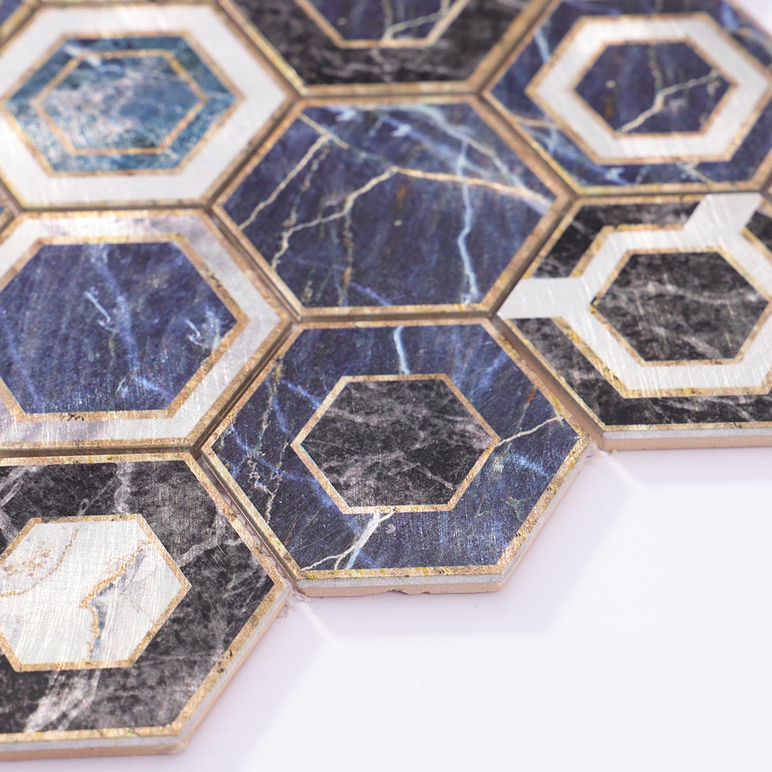 Angle shot of blue marble look hexagon mosaic showing metallic edge