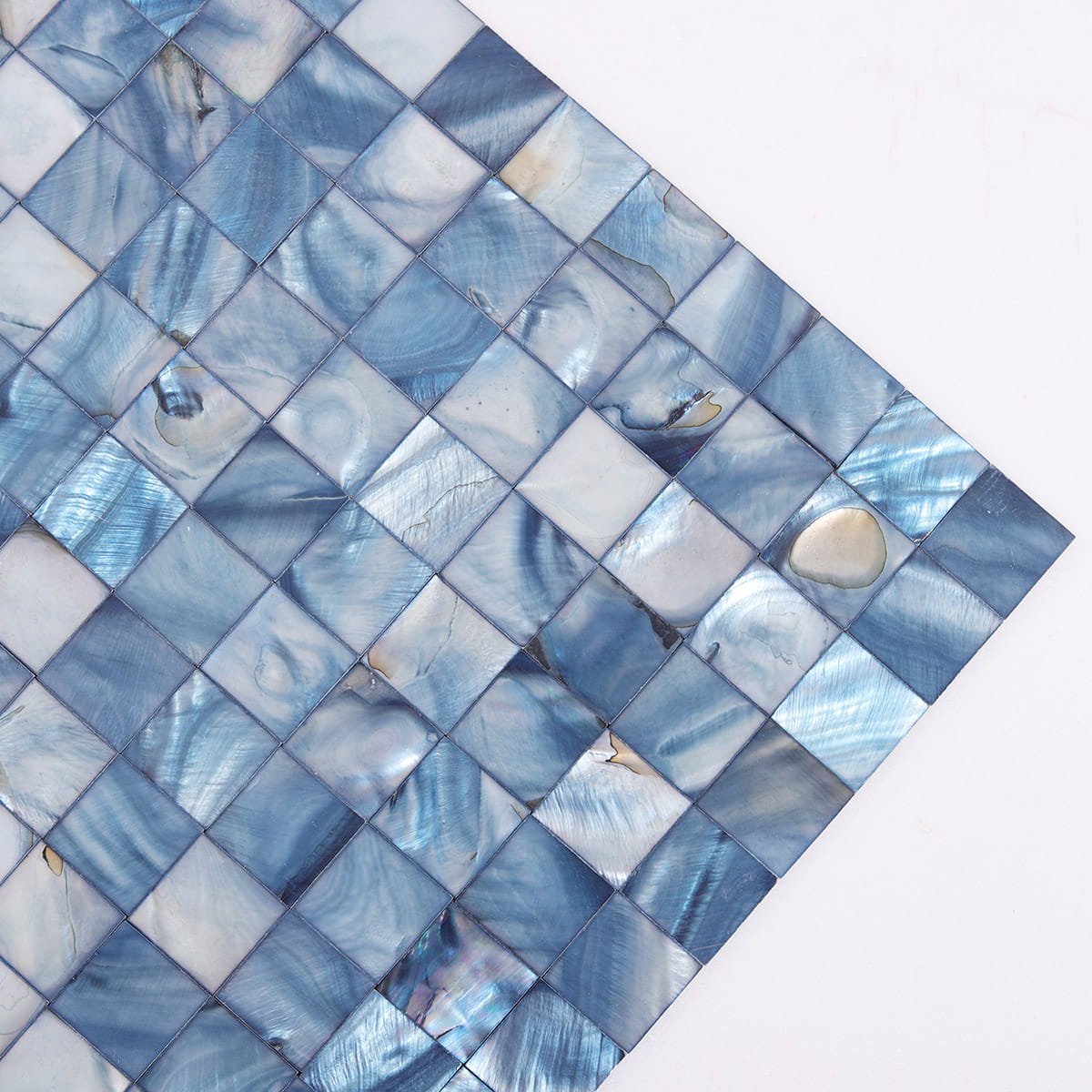 Angled close-up of blue shell mosaic tiles with natural pearlescent textures