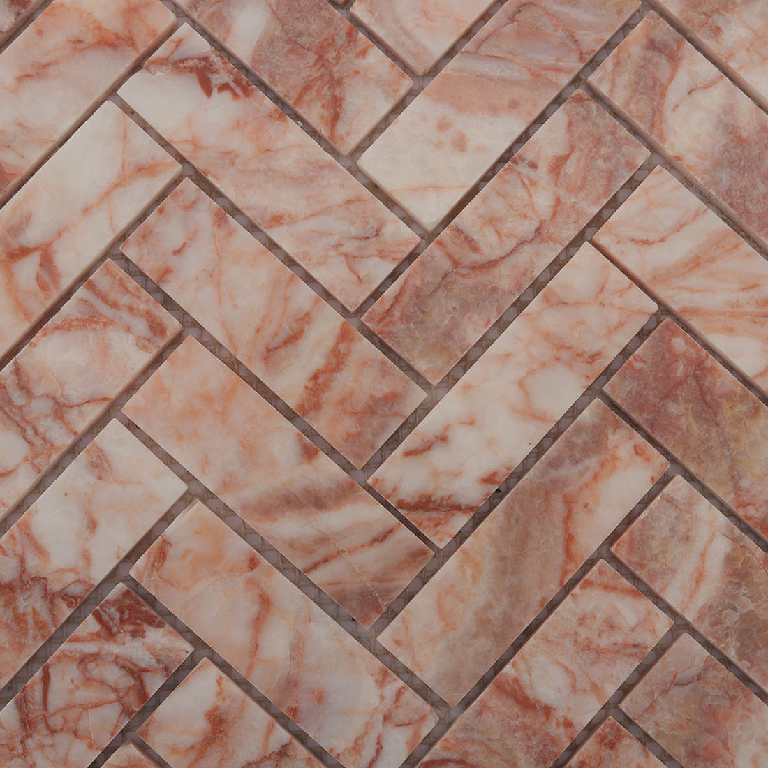 Blush veined marble herringbone mosaic pattern with natural stone variation