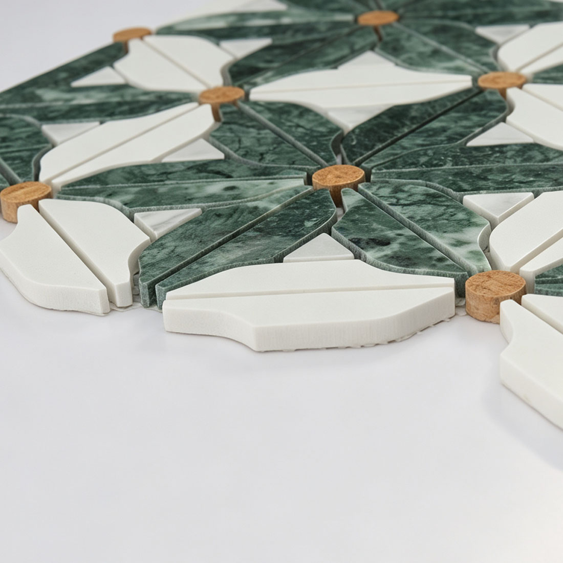 Raised botanical marble mosaic surface with green leaves and ivory floral pieces