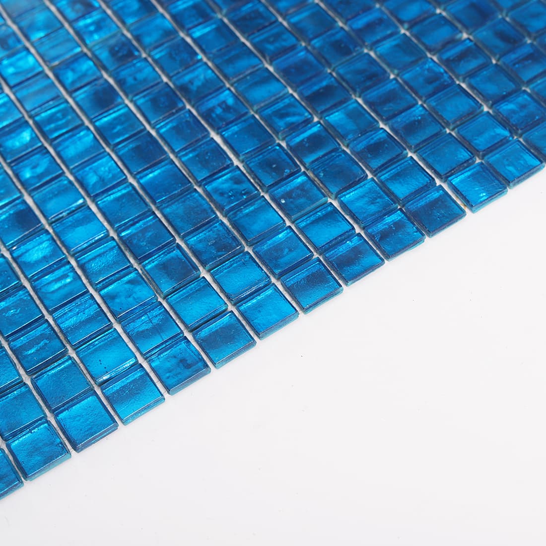 Angled detail of bright blue square glass mosaic tile sheet