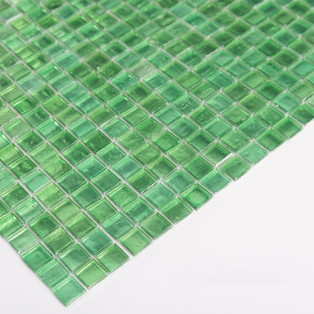 Side view showing the thickness of bright green square glass mosaic tile