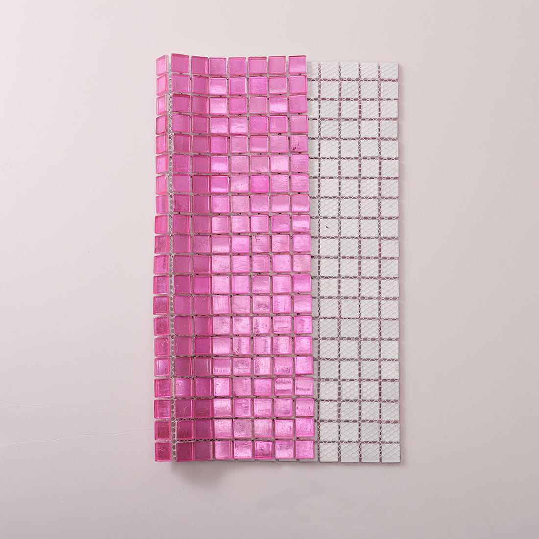 Mesh backing view of bright pink foil-backed glass mosaic tile sheet