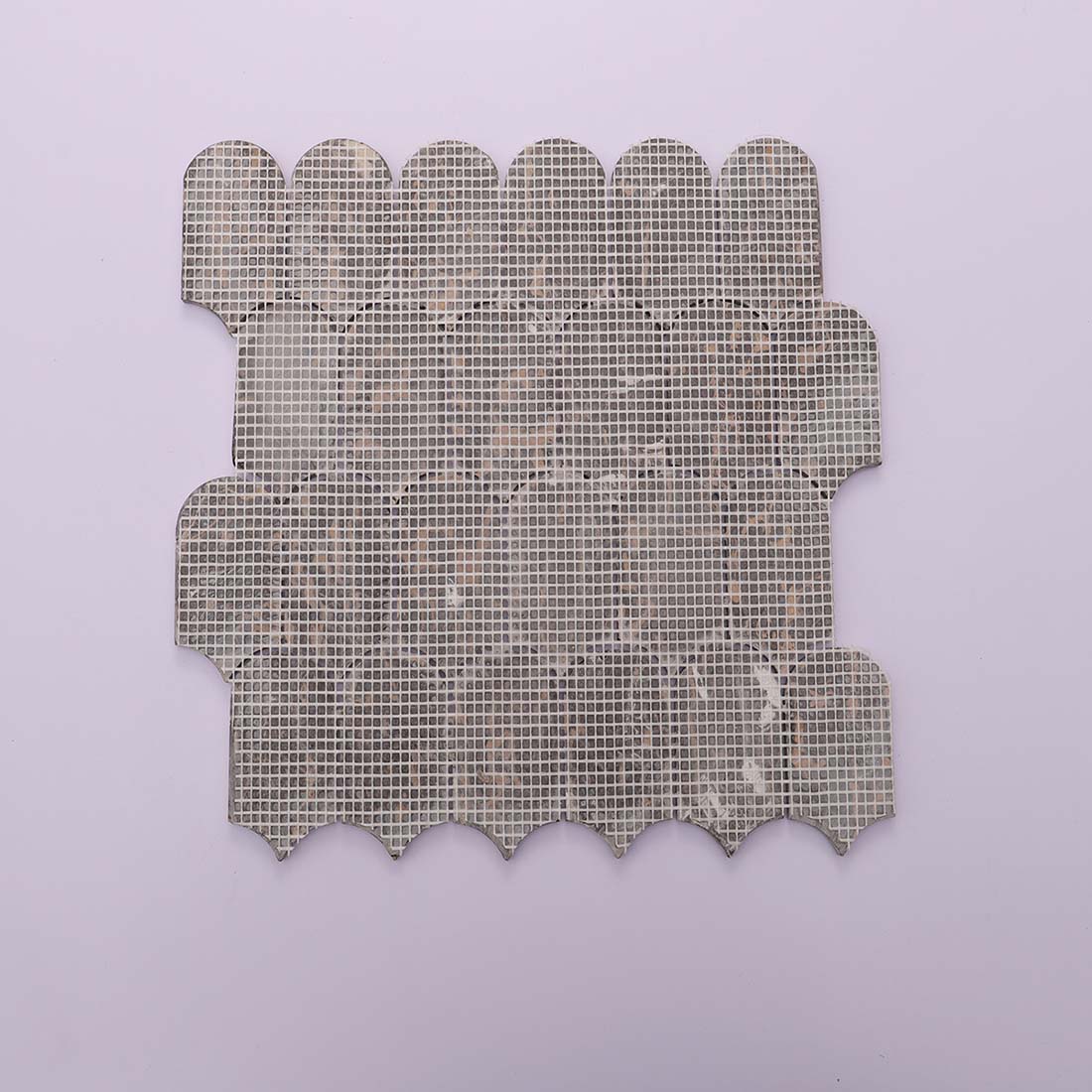 Mesh backing on the reverse side of brown marble mosaic tile