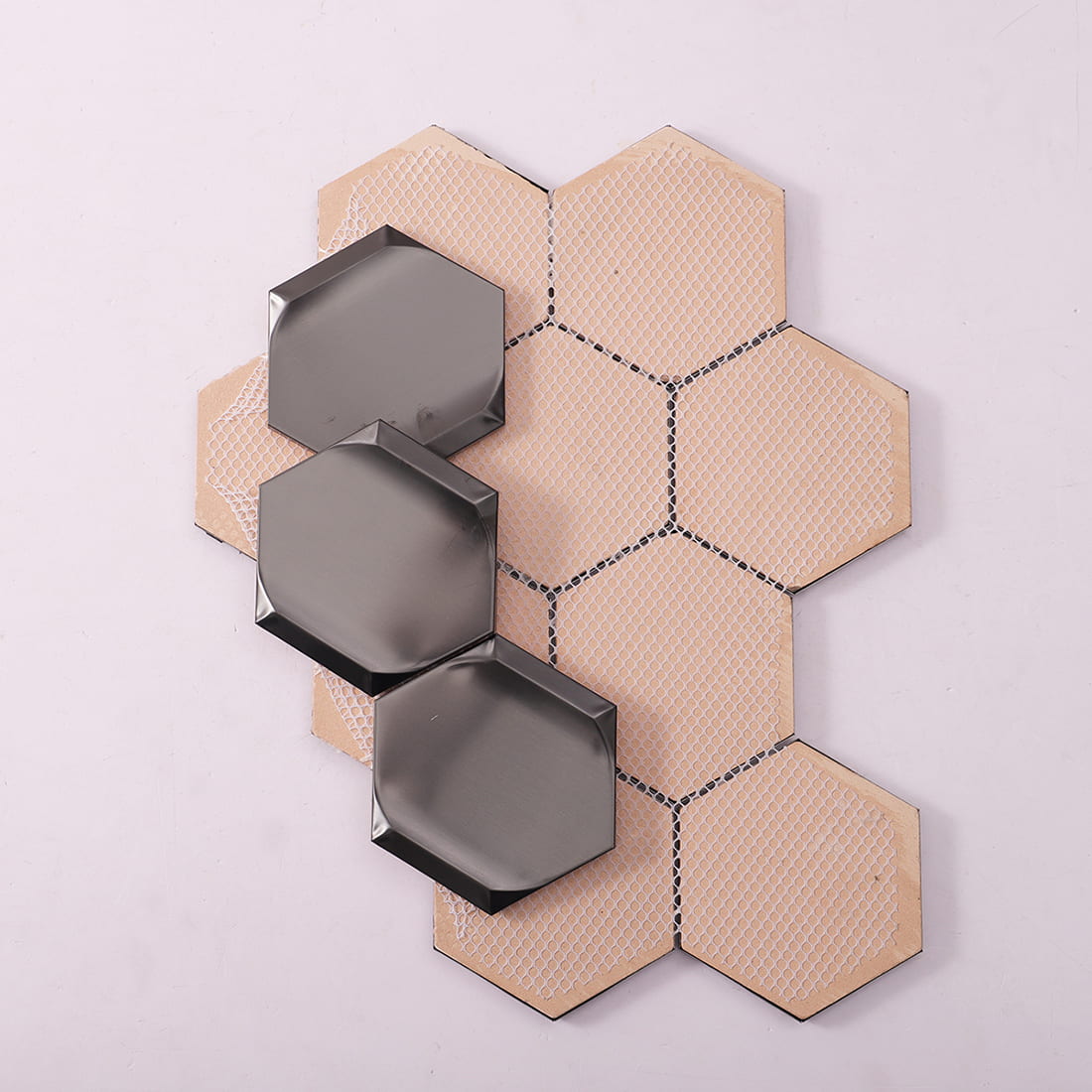 Side and mesh backing view of brushed black hexagon stainless steel mosaic tile