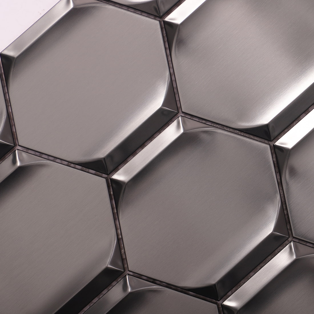 Close-up of brushed black 3D hexagon stainless steel mosaic surface