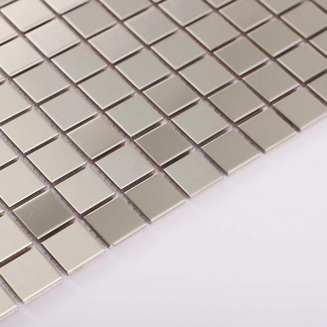 Close-up of brushed silver square metal mosaic tile surface