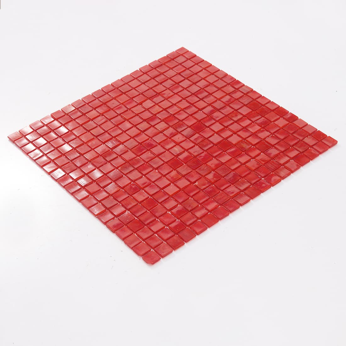 Angled view of cherry red square glass mosaic tile sheet
